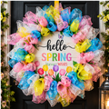 Spring wreath with pink, turquoise, yellow, and white mesh curls surrounding a Hello Spring tulip sign